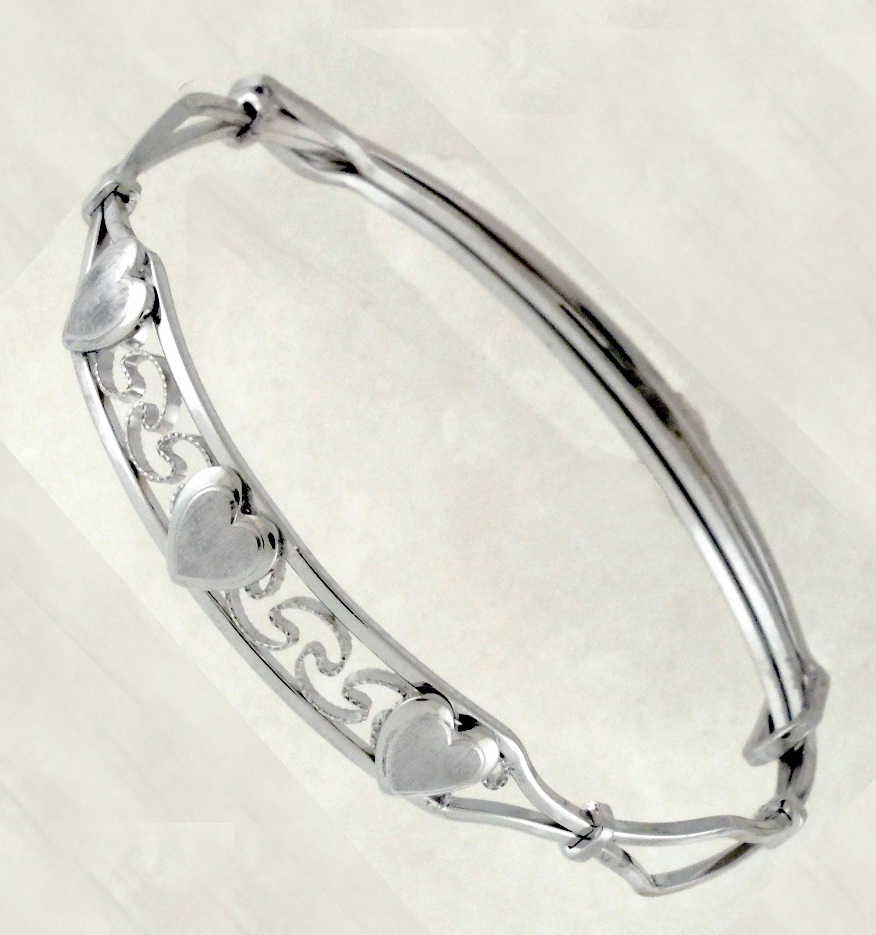 S.S. BANGLE BRACELET W/HEARTS ADJUSTABLE